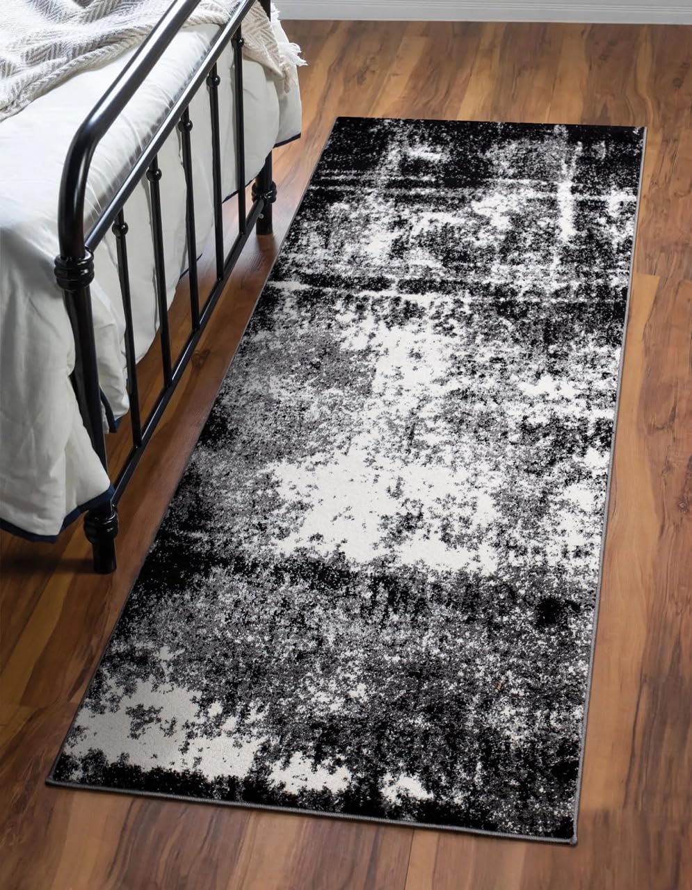 Black runner rug styled in a long hallway