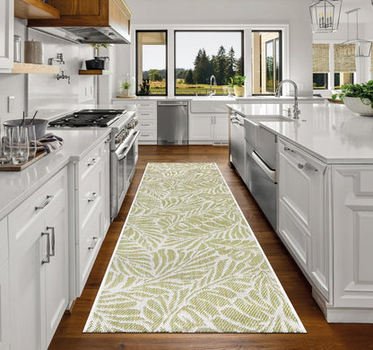Top-down view of the Green and ivory tropical leaf outdoor rug