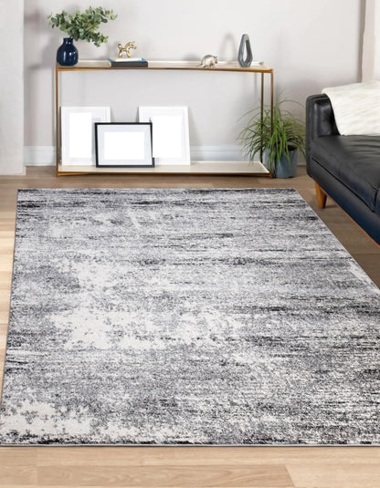 8x10 cream and gray abstract rug paired with a linen sectional