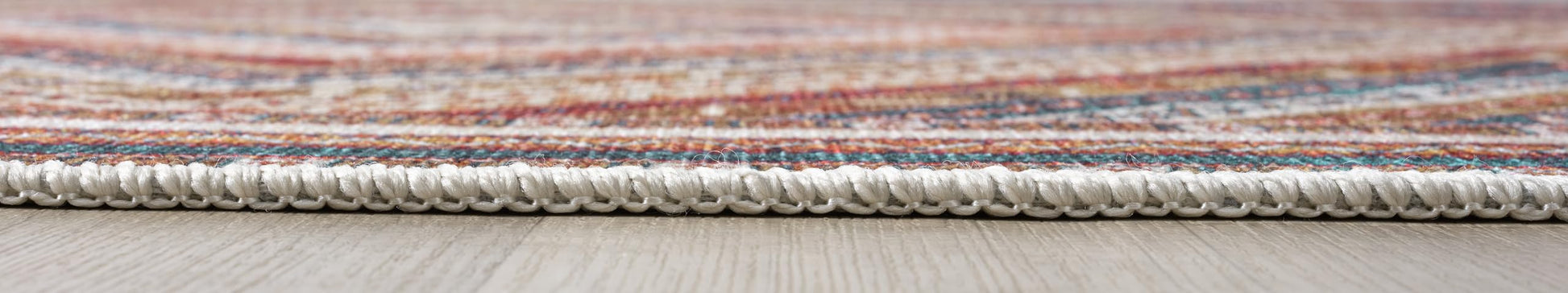 Detail of the geometric zigzag and star motifs on the cream rug