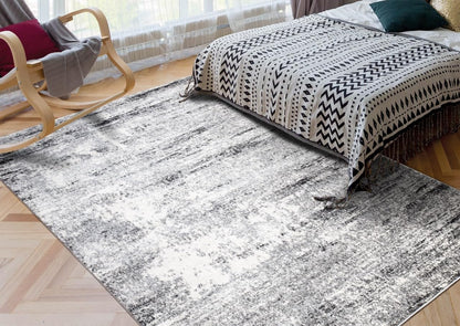 Cream and gray rug under a coffee table with neutral decor