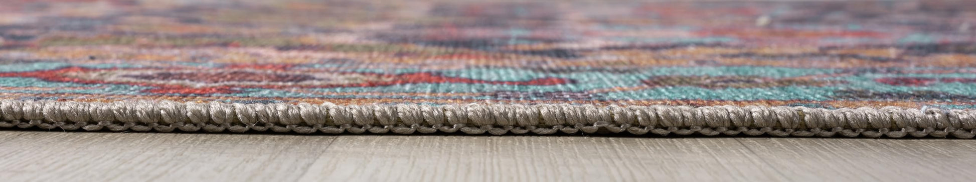 Detail of the rust and ochre floral motifs on the teal field
