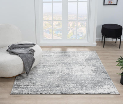 Cream rug under a navy sofa with light wood furniture