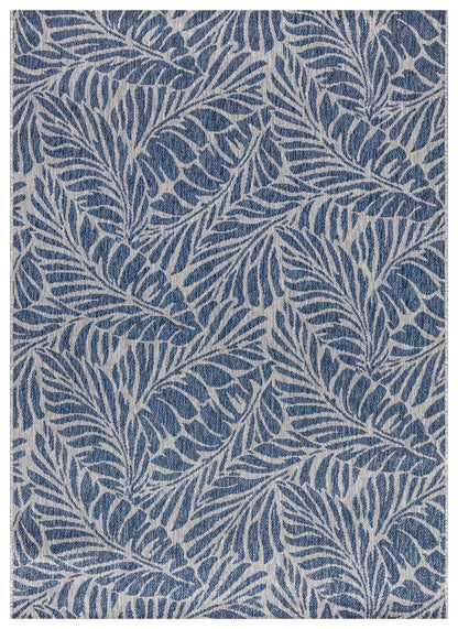 Navy and gray tropical leaf outdoor rug on covered teak patio