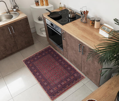 Striped Baluch rug under a leather sofa with woven baskets