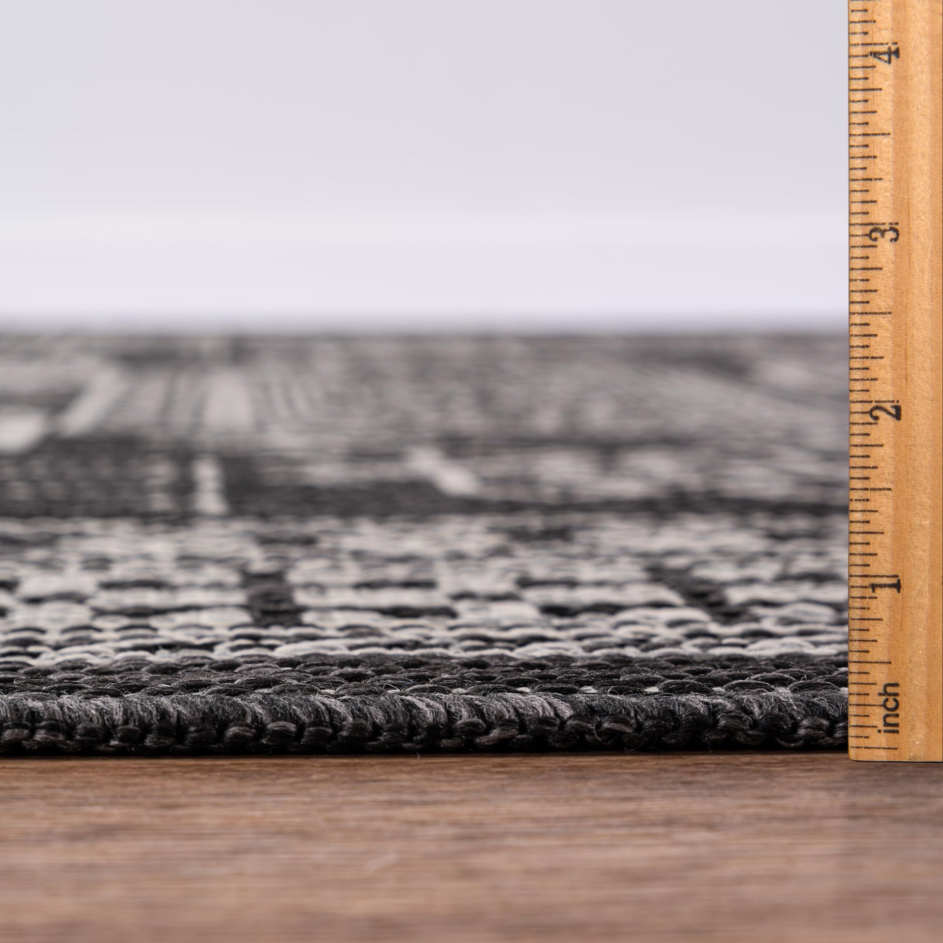 Bound edge detail of the Black tribal heritage outdoor rug