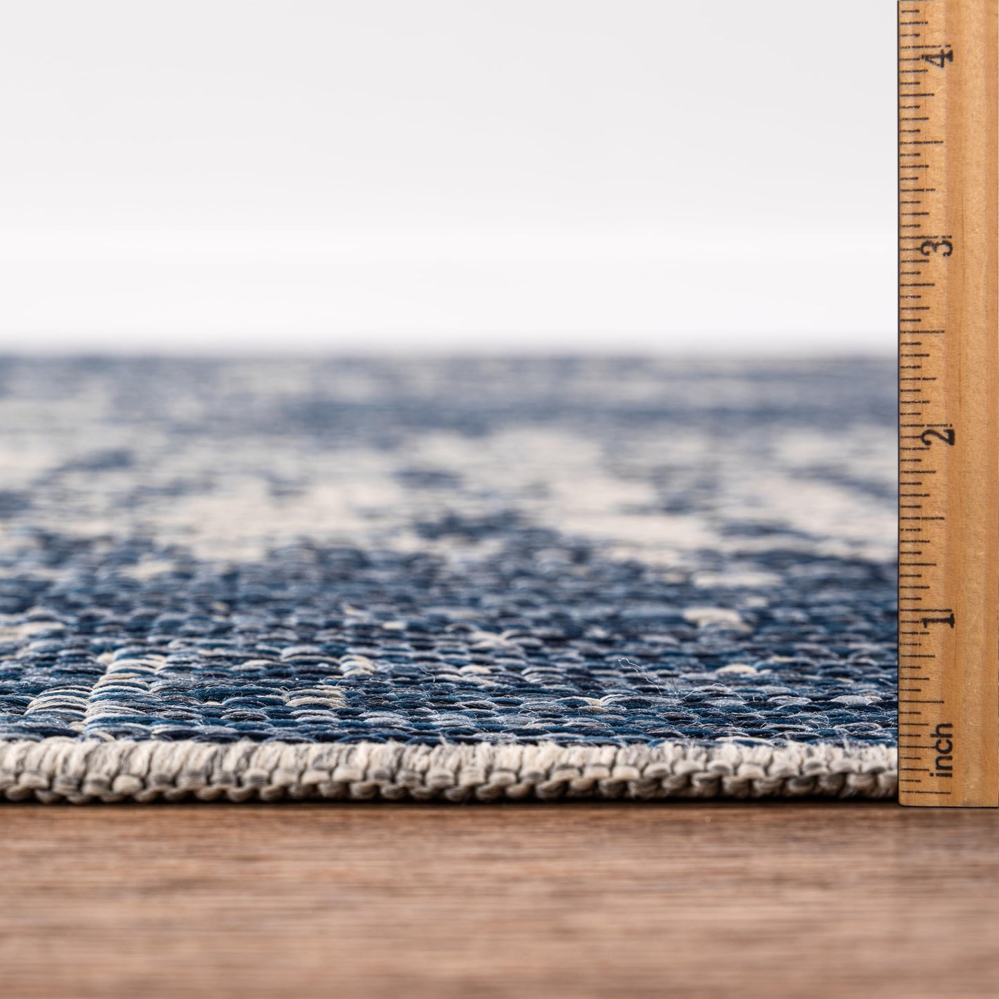 Bound edge detail of the Navy modern abstract outdoor rug