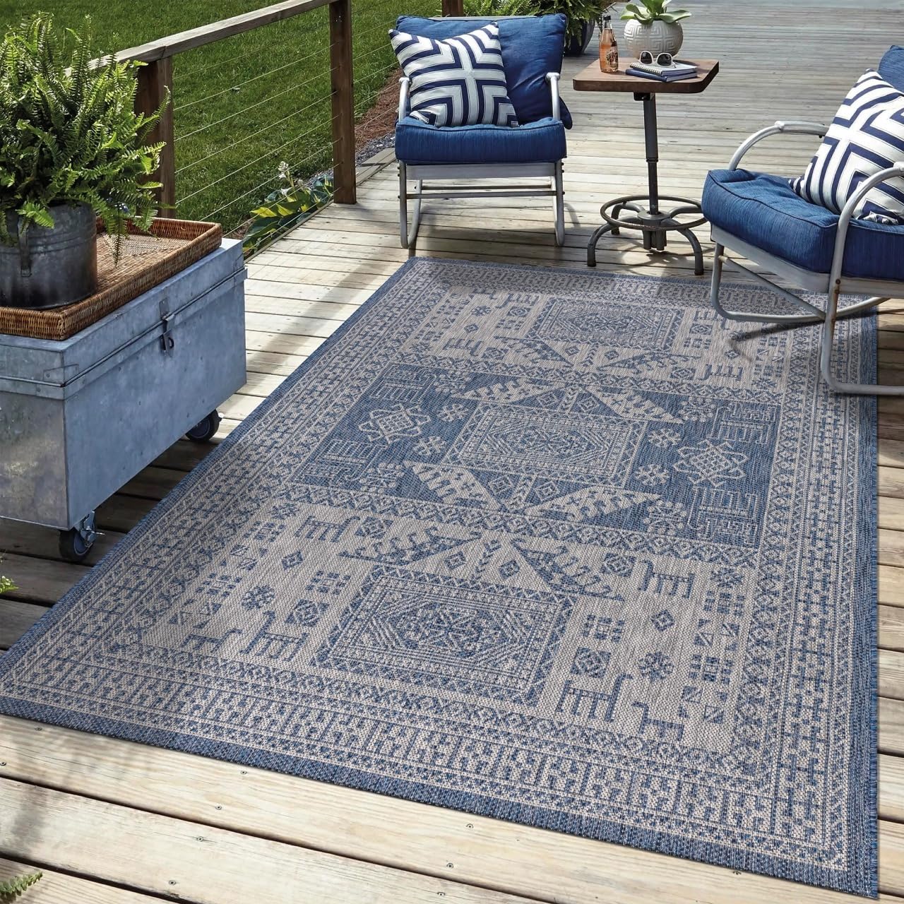 Navy tribal outdoor rug in garden seating area with greenery