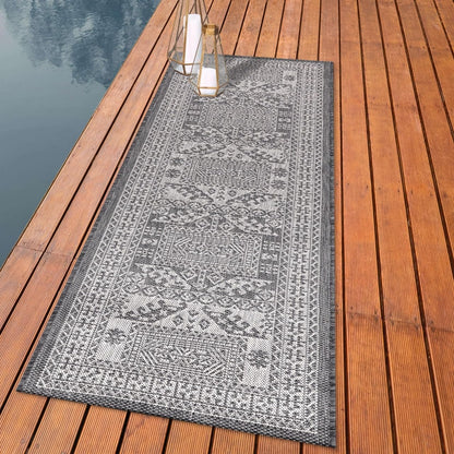Tribal Caucasian outdoor rug styled with outdoor dining furniture