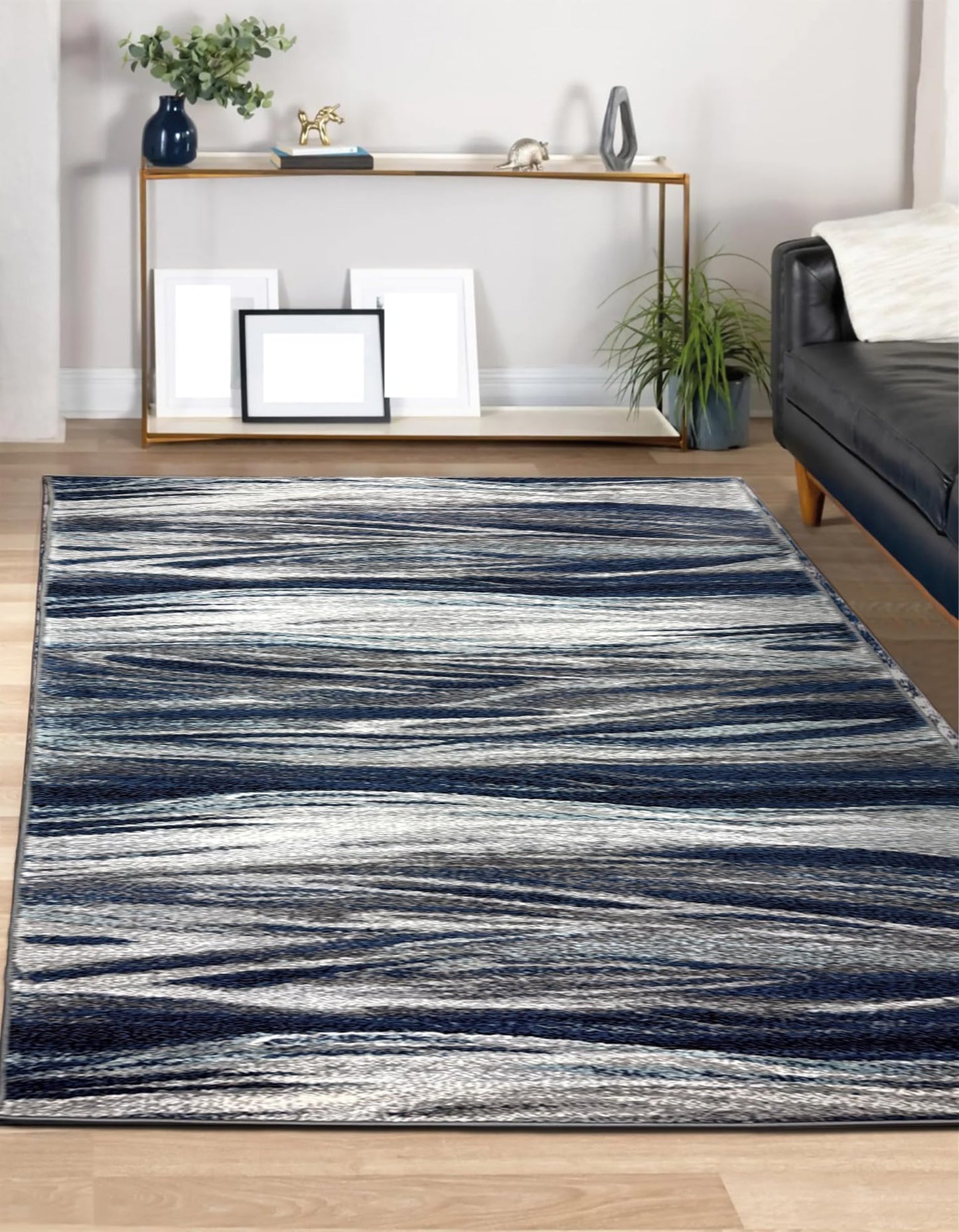 Low pile navy abstract rug on light wood flooring