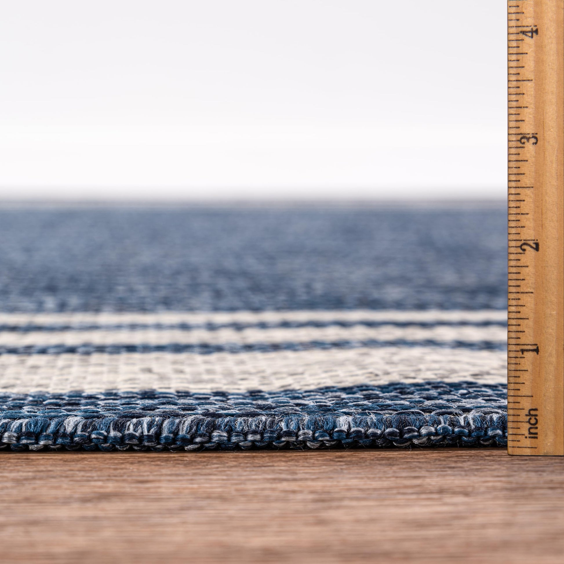 Bound edge detail of the navy bordered outdoor rug