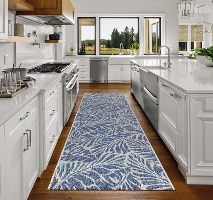 Top-down view of the Navy and gray tropical leaf outdoor rug