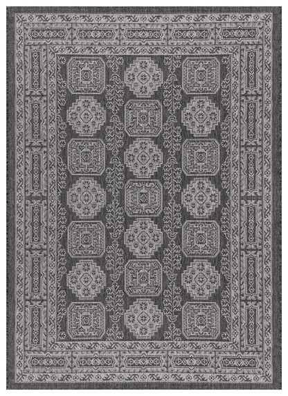 Black and gray Anatolian medallion outdoor rug on covered teak patio