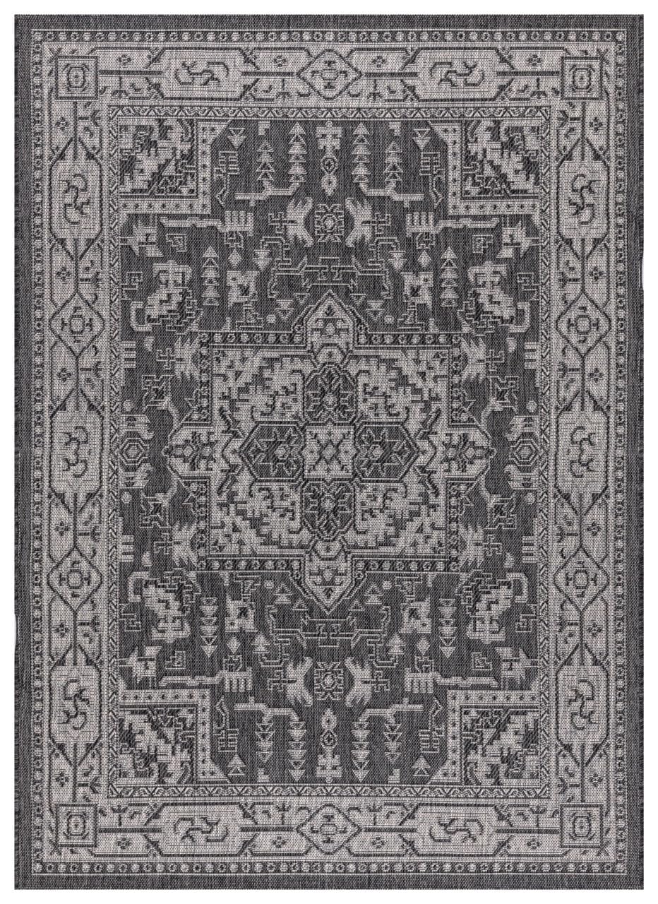 Black and gray Persian medallion outdoor rug on covered teak patio