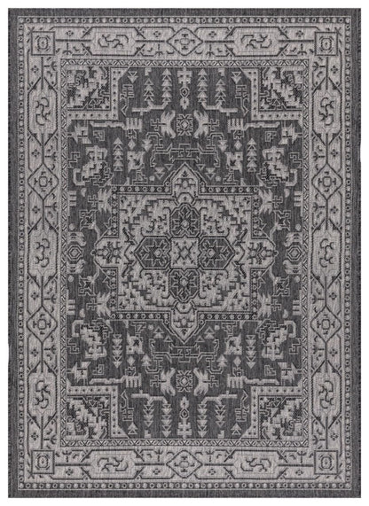 Black and gray Persian medallion outdoor rug on covered teak patio