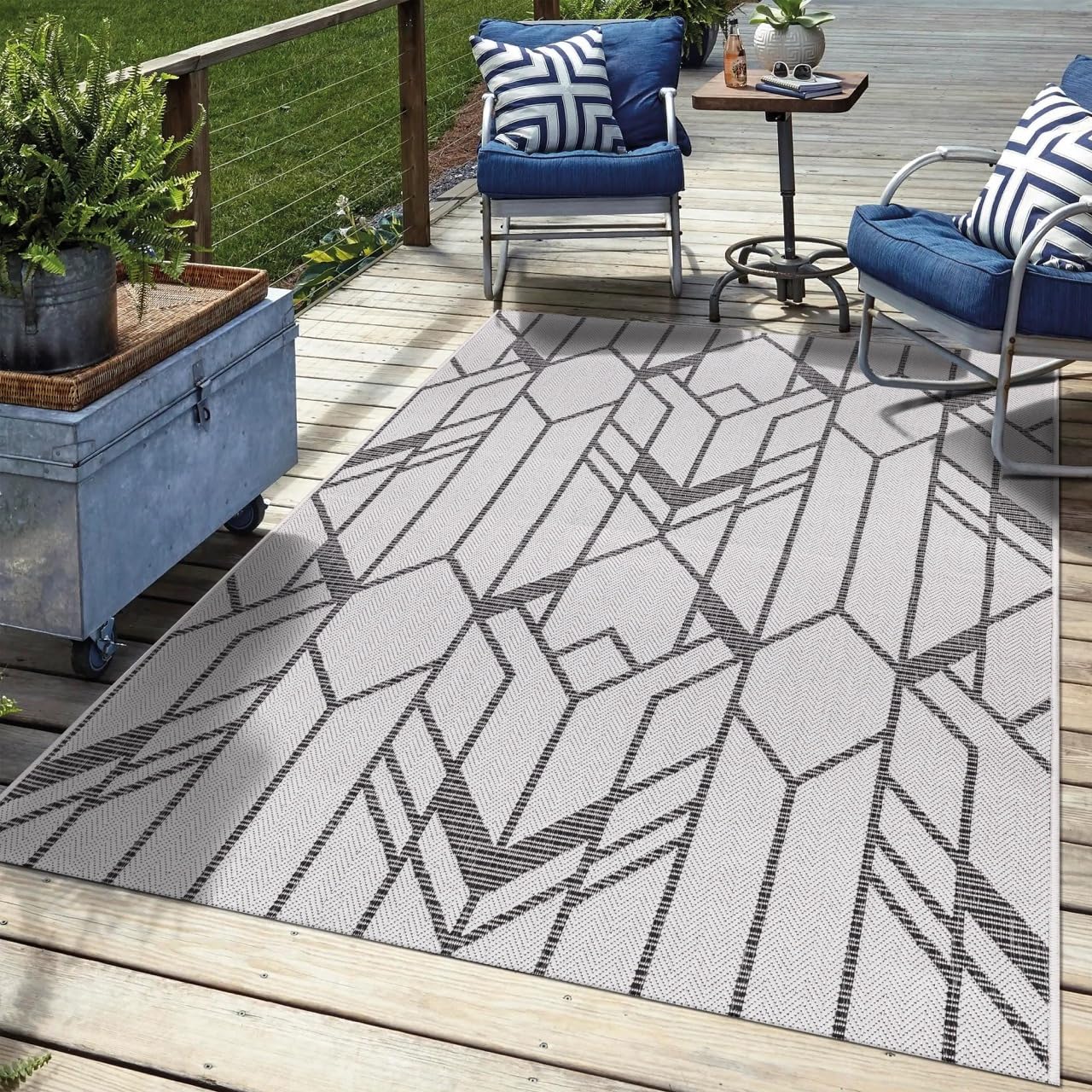 Black Art Deco outdoor rug on rooftop terrace with city views