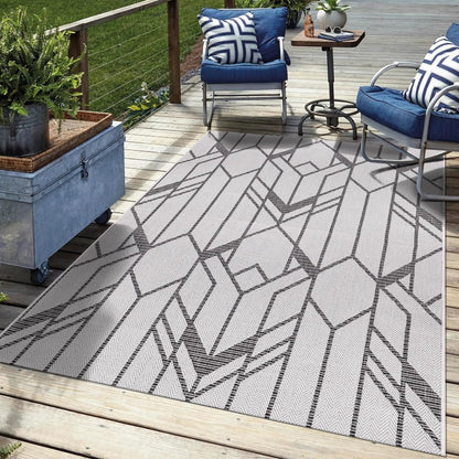 Black Art Deco outdoor rug on rooftop terrace with city views
