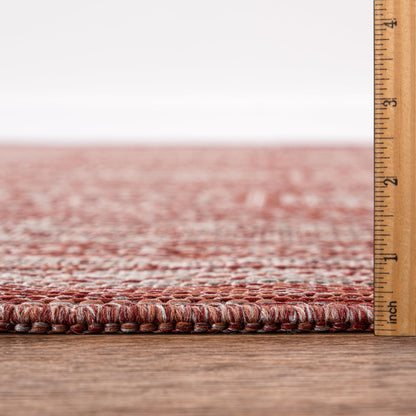 Terracotta Turkmen rug in mediterranean-style screened porch setting