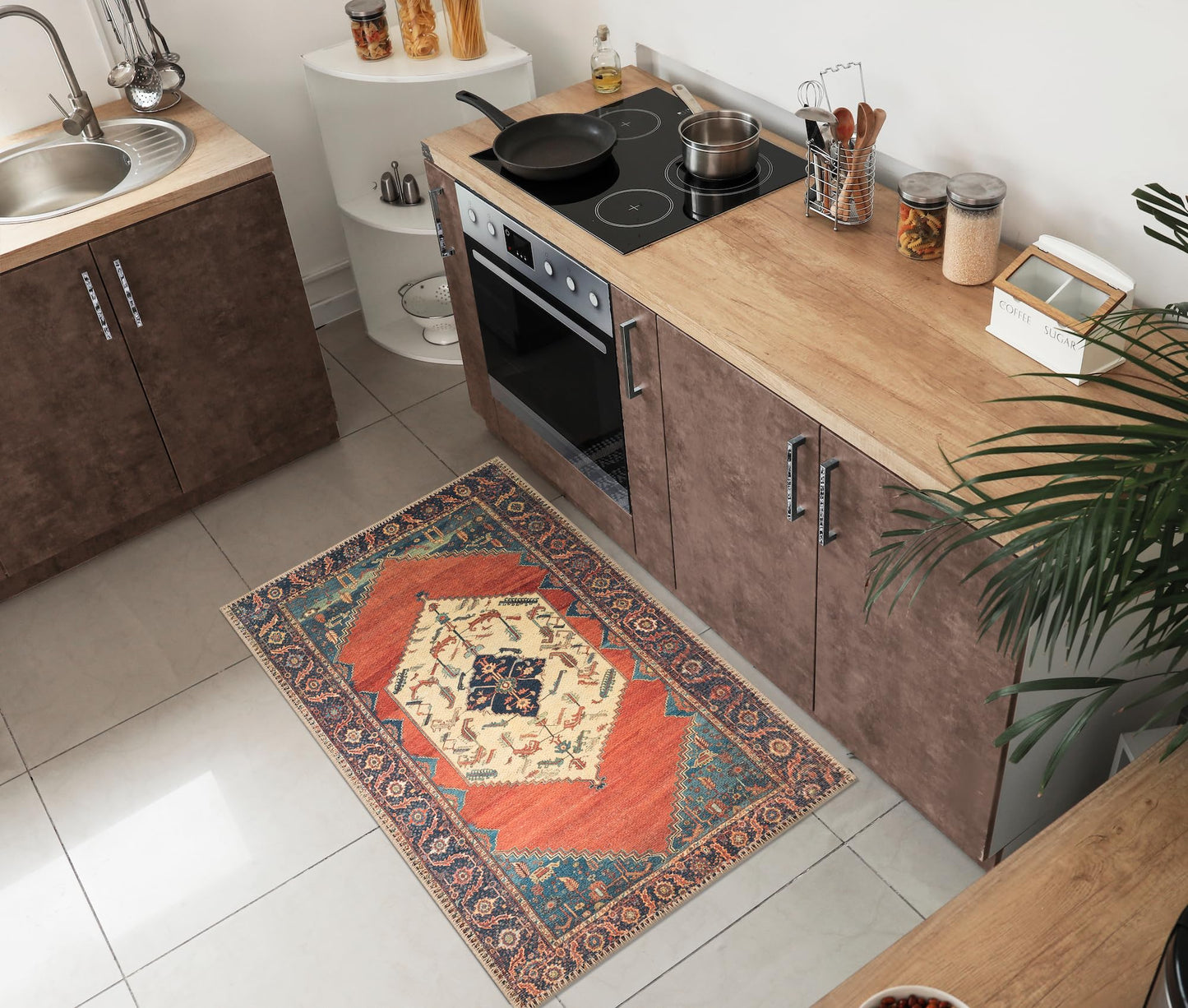 Tribal Persian rug under a leather sofa with brass accents