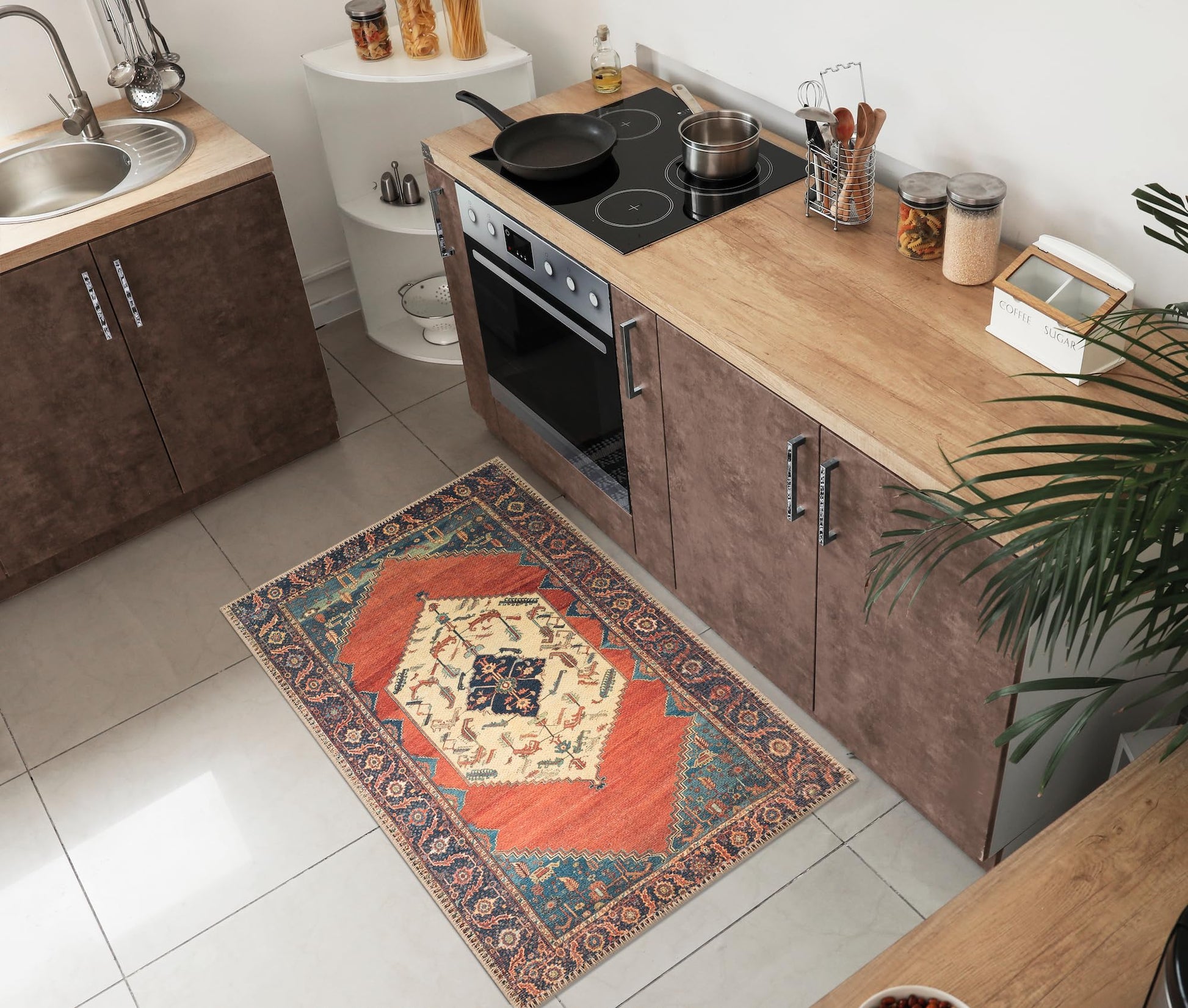 Tribal Persian rug under a leather sofa with brass accents