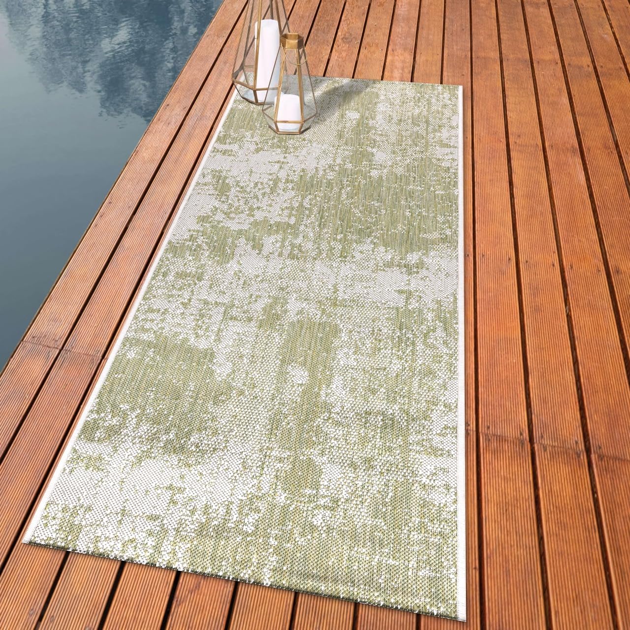 Distressed painterly outdoor rug styled with outdoor dining furniture