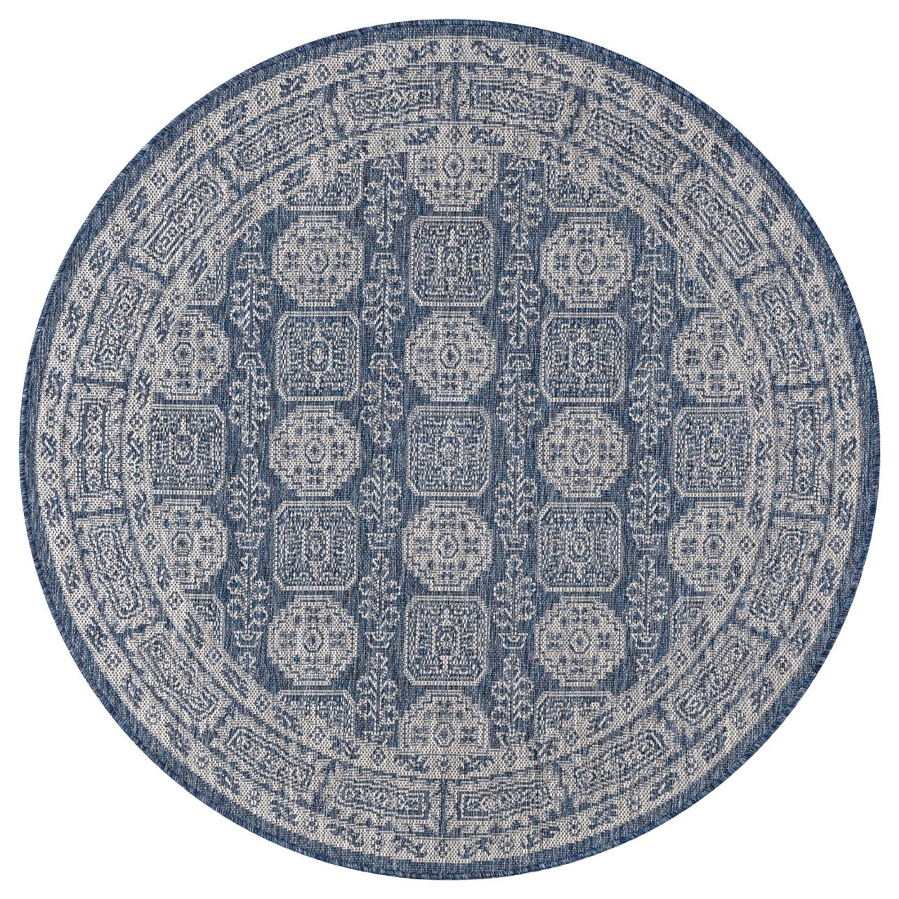 Navy Turkmen rug in mediterranean-style screened porch setting