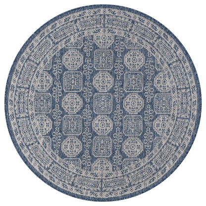 Navy Turkmen rug in mediterranean-style screened porch setting
