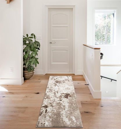 Tan rug under a coffee table with neutral decor
