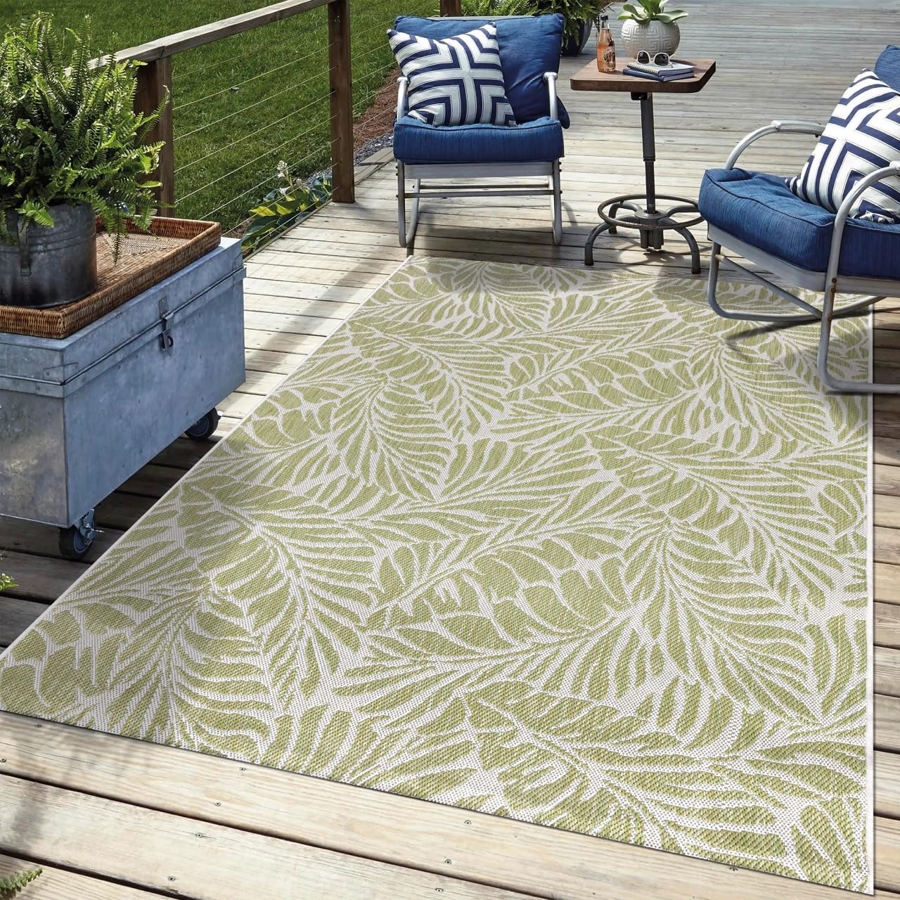 Green tropical outdoor rug in garden seating area with greenery