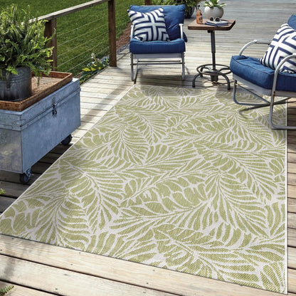 Green tropical outdoor rug in garden seating area with greenery