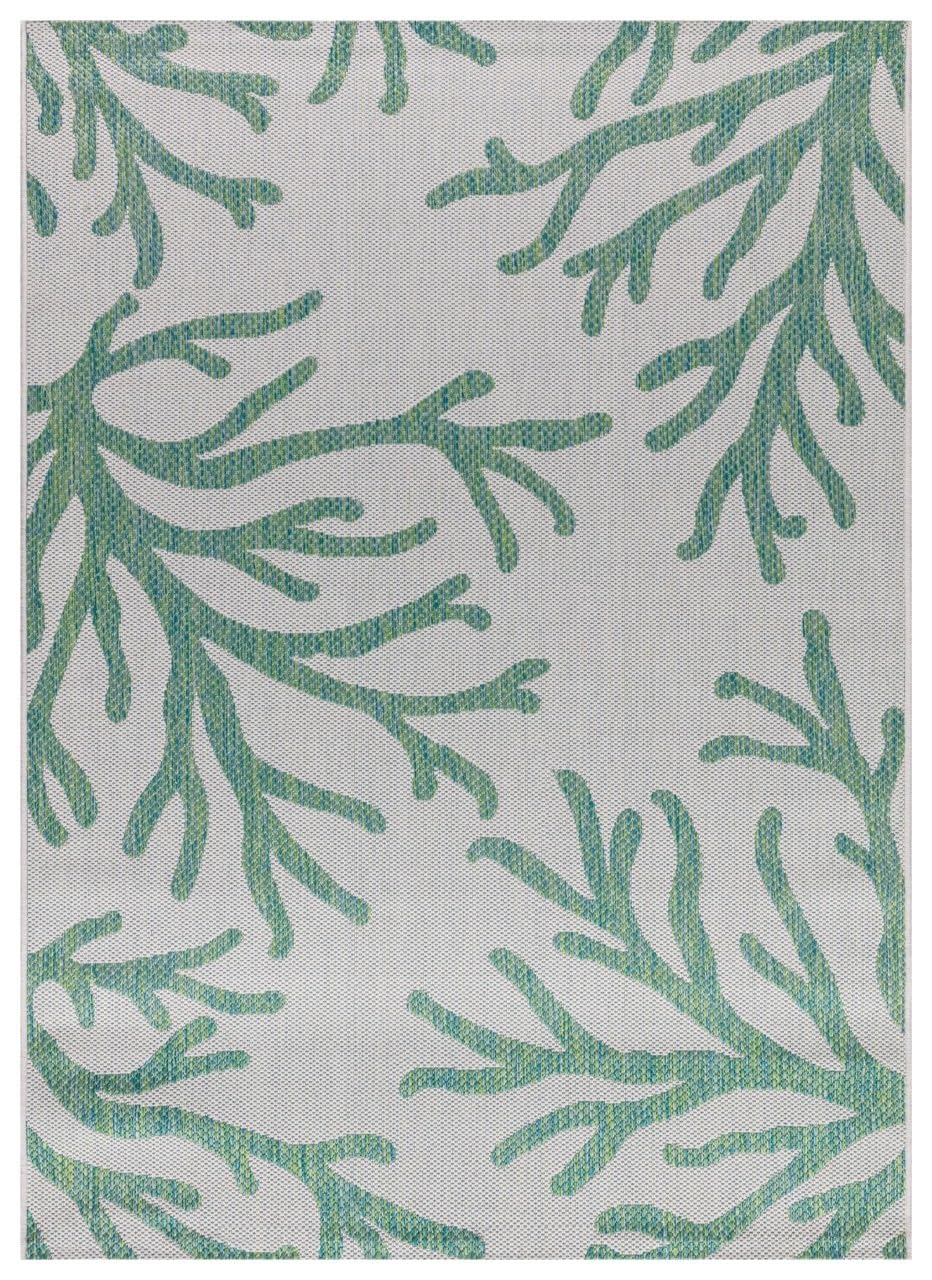 Green and ivory coral pattern outdoor rug on covered teak patio