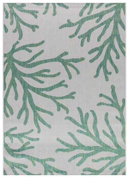 Green and ivory coral pattern outdoor rug on covered teak patio