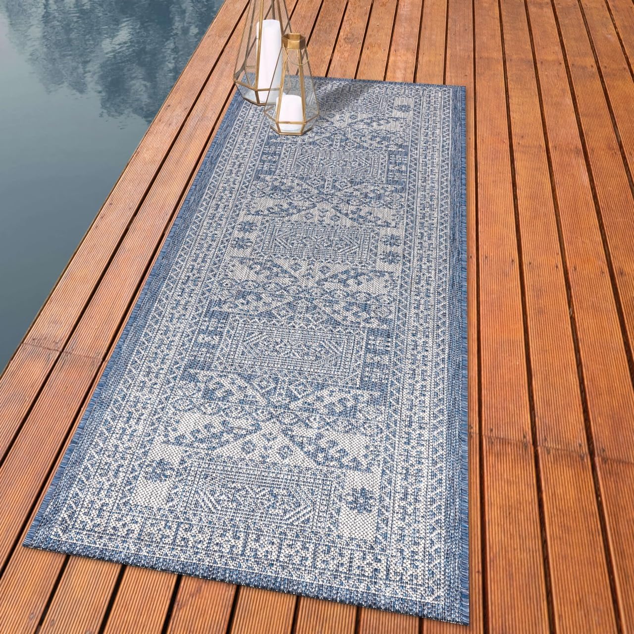 Tribal Caucasian outdoor rug styled with outdoor dining furniture