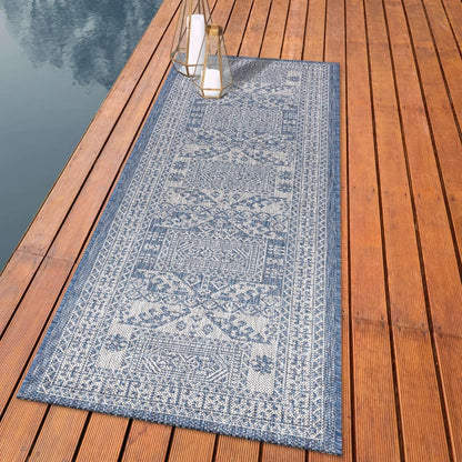 Tribal Caucasian outdoor rug styled with outdoor dining furniture