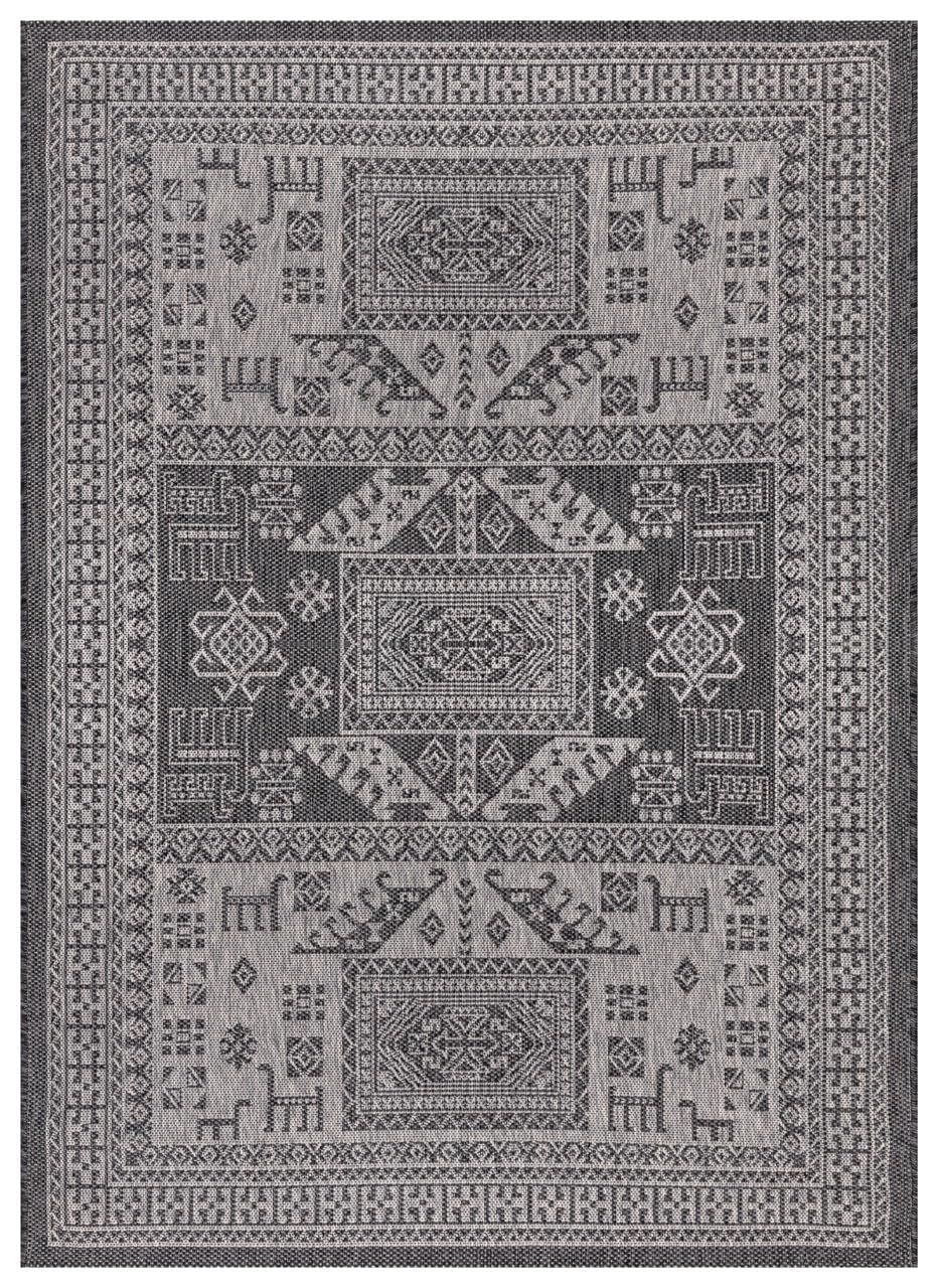 Black and gray tribal heritage outdoor rug on covered teak patio