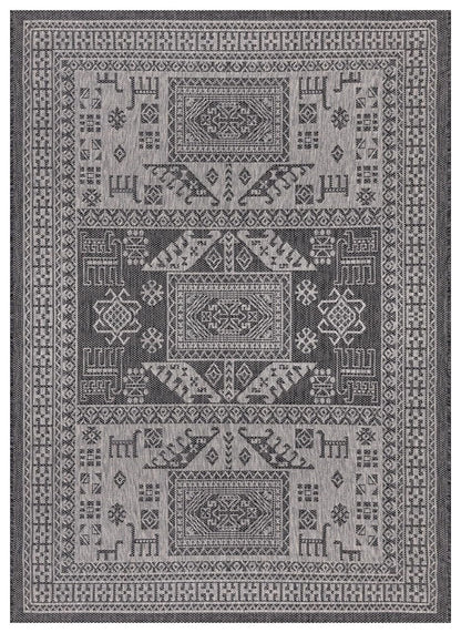 Black and gray tribal heritage outdoor rug on covered teak patio