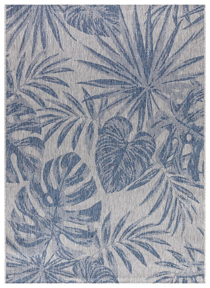 Navy and ivory tropical jungle outdoor rug on covered teak patio