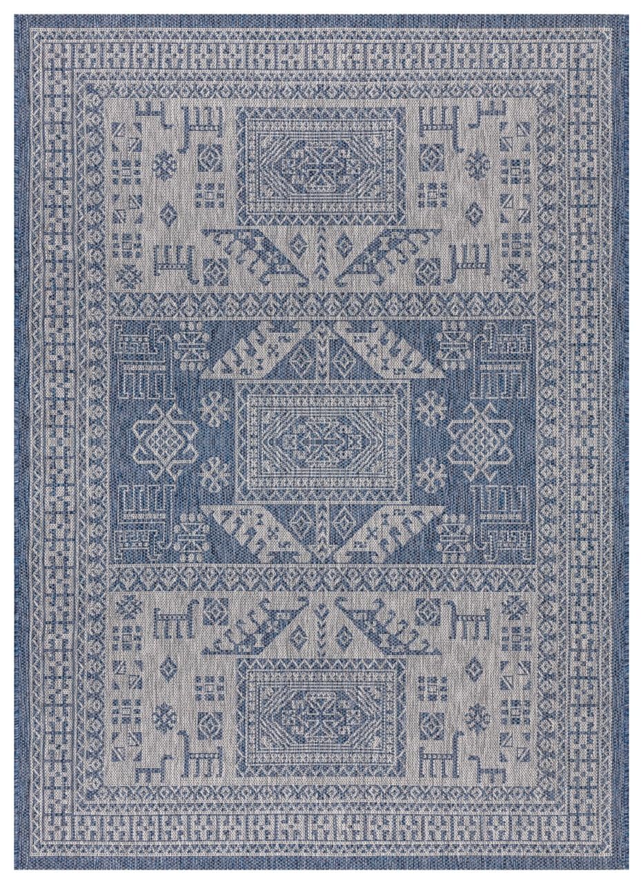 Navy and gray tribal heritage outdoor rug on covered teak patio