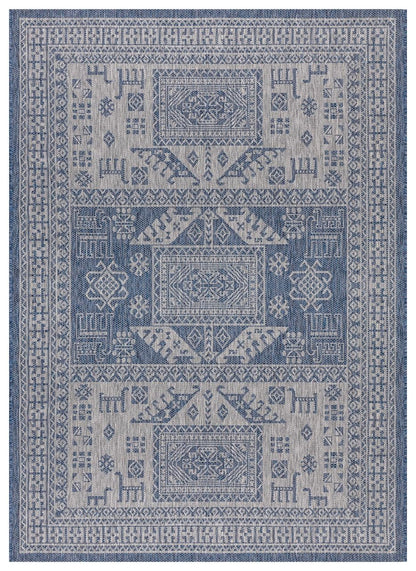 Navy and gray tribal heritage outdoor rug on covered teak patio