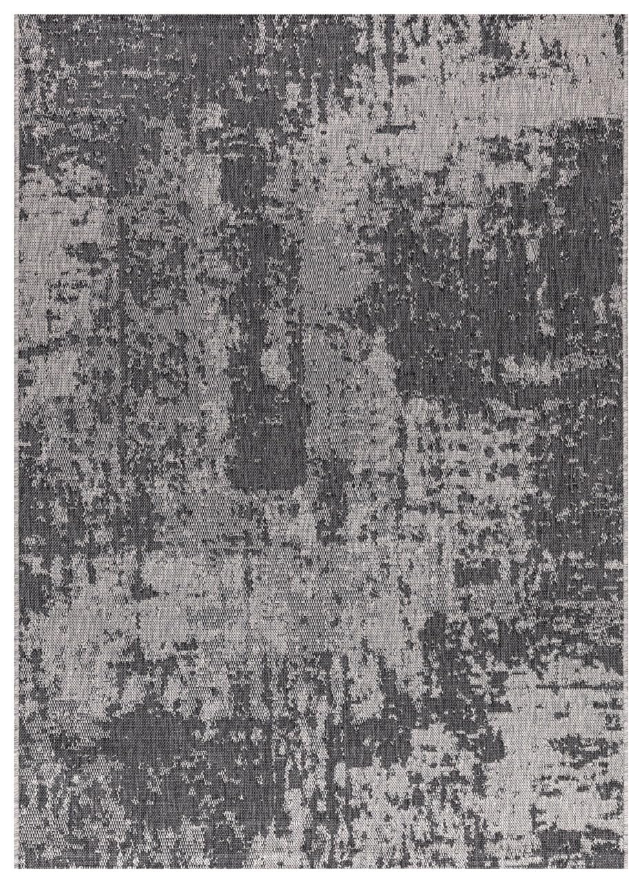 Black and ivory modern abstract outdoor rug on covered teak patio