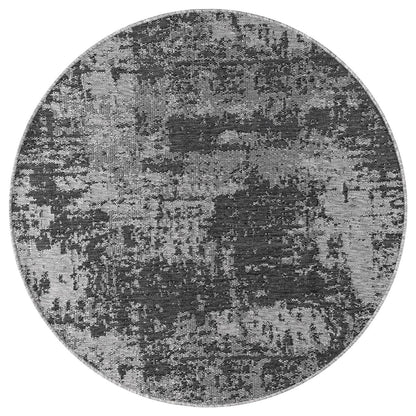 Black and ivory abstract rug in screened porch setting