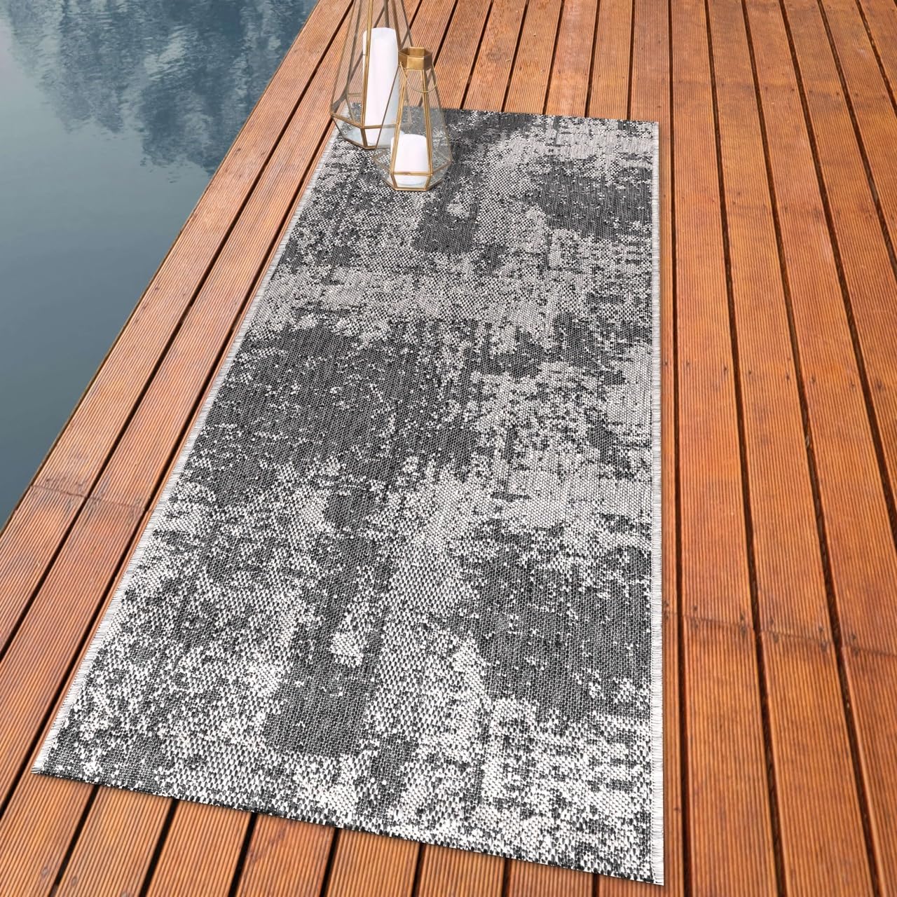 Distressed painterly outdoor rug styled with outdoor dining furniture