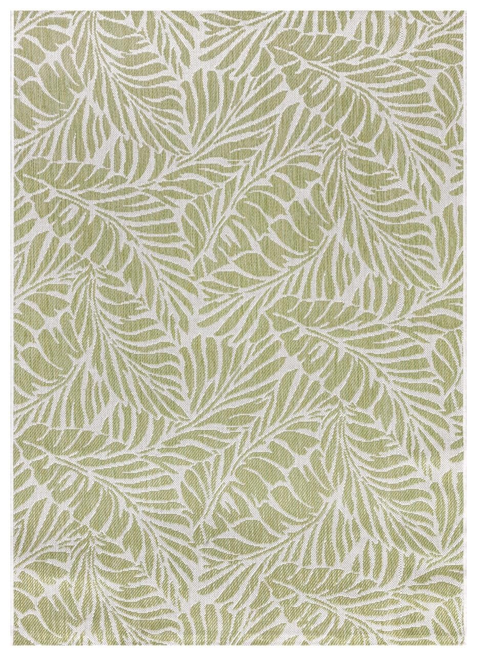 Green and ivory tropical leaf outdoor rug on covered teak patio