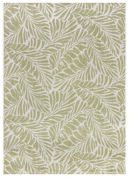 Green and ivory tropical leaf outdoor rug on covered teak patio