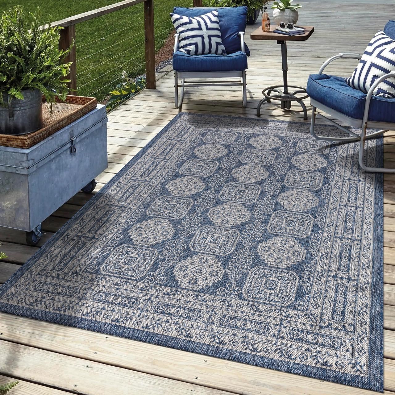 Navy Anatolian outdoor rug in garden seating area with greenery