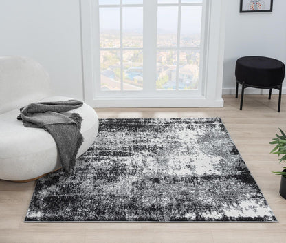 Black abstract area rug under a cream sofa with oak coffee table