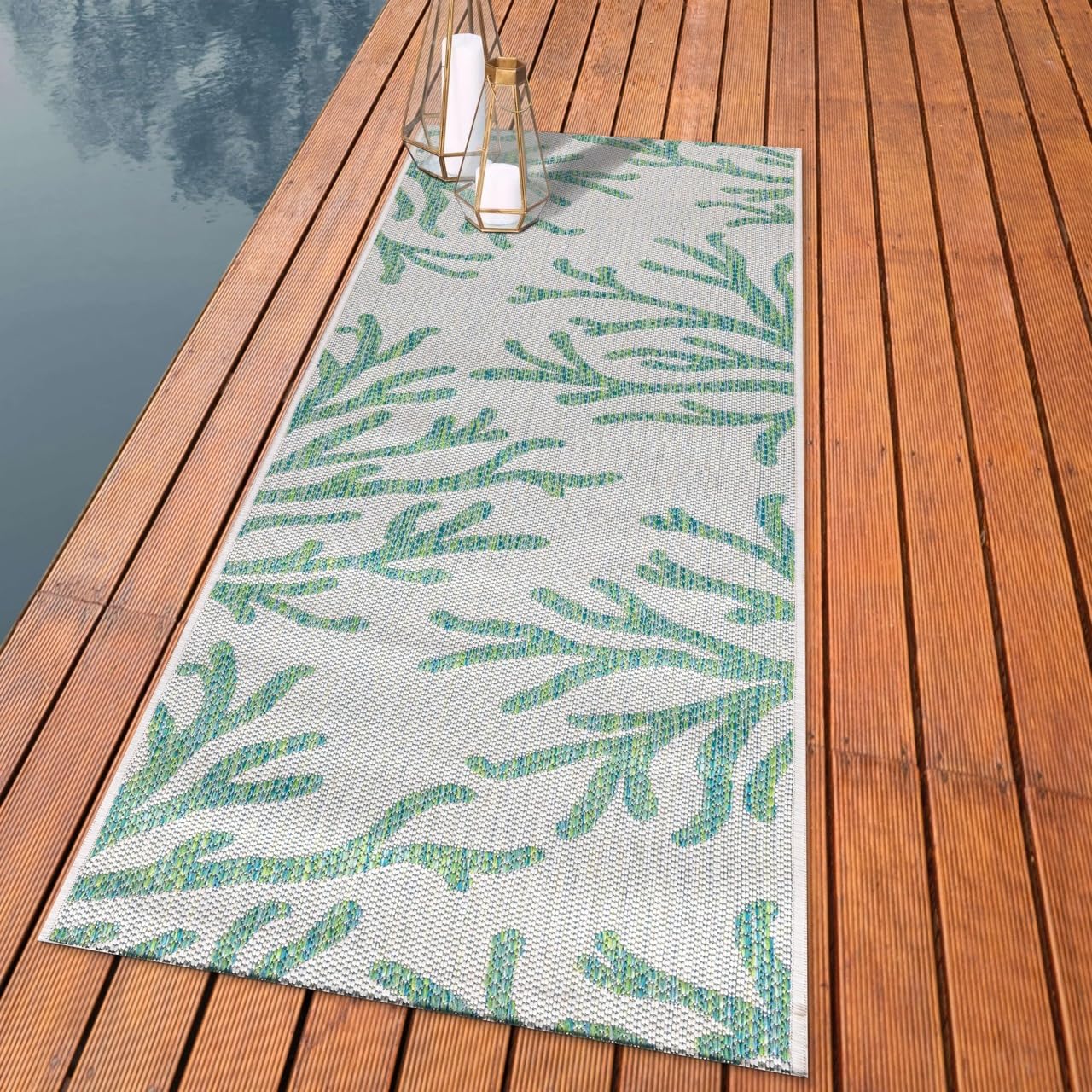 Coastal coral branch outdoor rug styled with rattan dining furniture