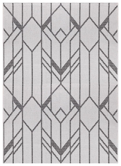 Black and ivory Art Deco geometric outdoor rug on covered urban patio