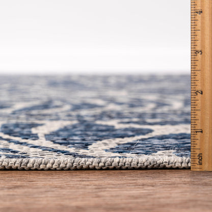 Bound edge detail of the Navy tropical leaf outdoor rug