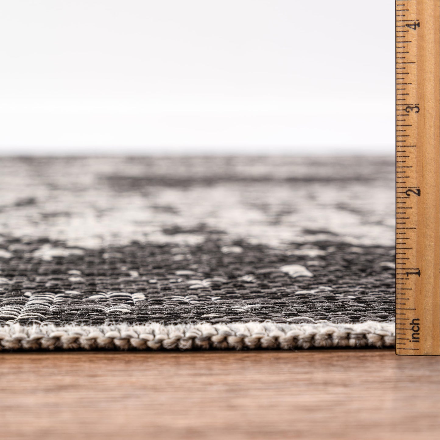 Bound edge detail of the Black modern abstract outdoor rug